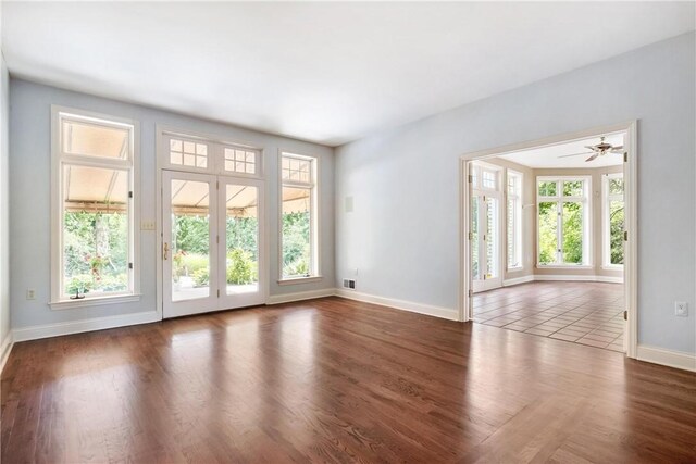 unfurnished room with ceiling fan and dark hardwood / wood-style floors