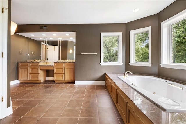 bathroom with vanity, a bathtub, and tile patterned floors