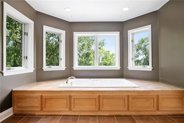 bathroom featuring a tub, plenty of natural light, and tile patterned flooring