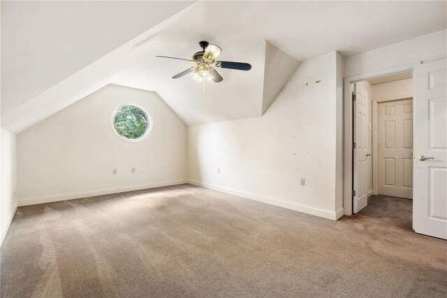 bonus room featuring ceiling fan, light carpet, and lofted ceiling