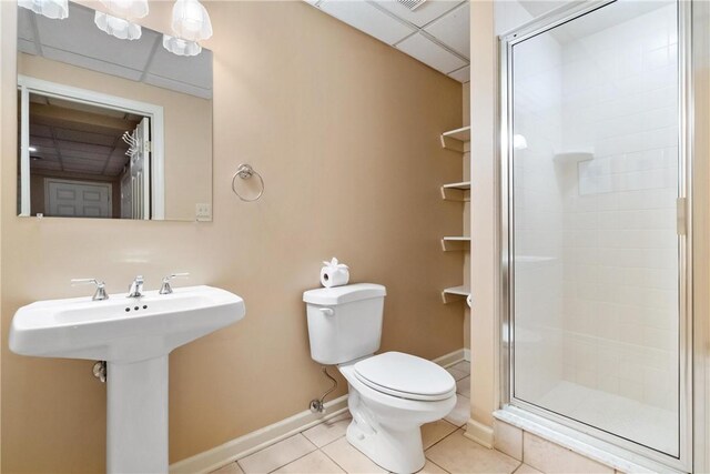 bathroom with sink, toilet, tile patterned floors, and an enclosed shower