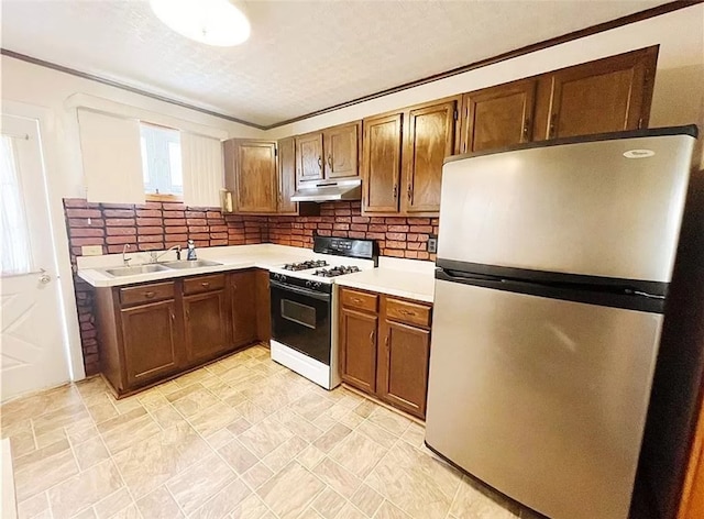 kitchen with stainless steel refrigerator, light tile patterned floors, white gas range, backsplash, and sink