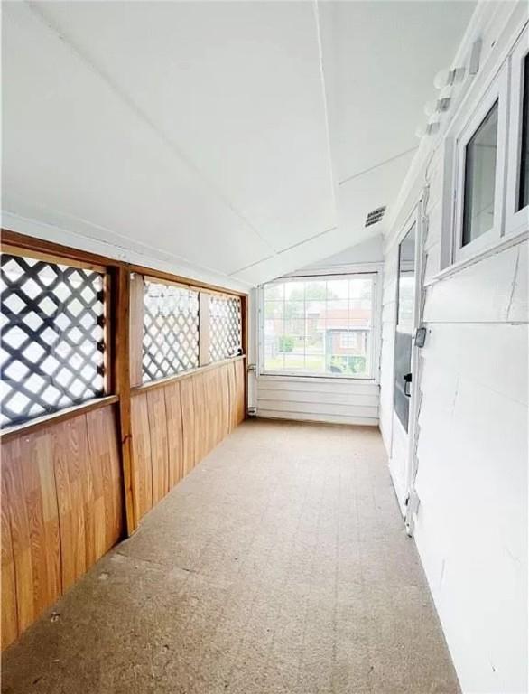 unfurnished sunroom with vaulted ceiling