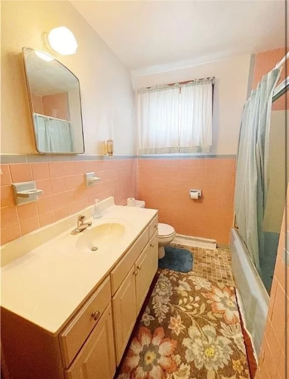 full bathroom featuring vanity, tile walls, and toilet