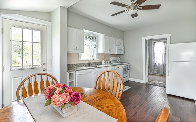 dining space featuring ceiling fan, plenty of natural light, dark wood-type flooring, and sink