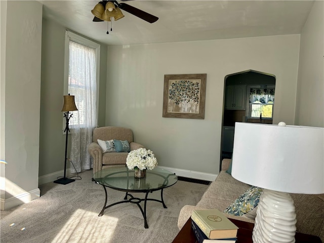 sitting room featuring ceiling fan and carpet floors