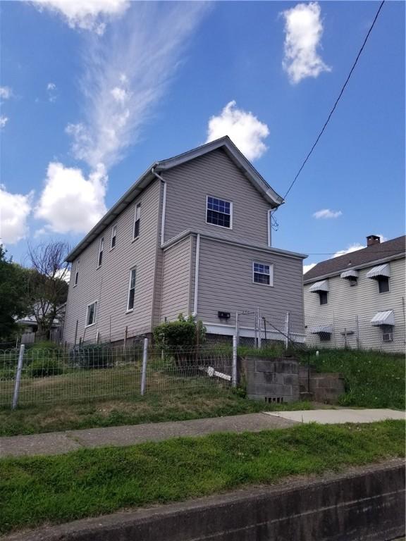 view of side of property featuring fence