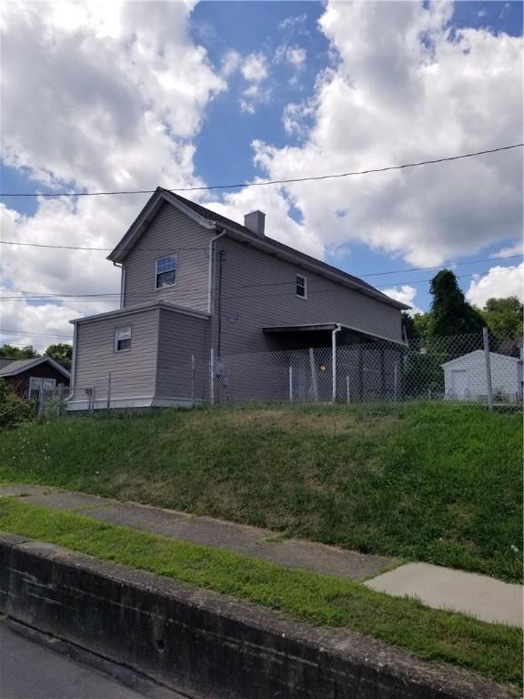 view of side of property featuring fence