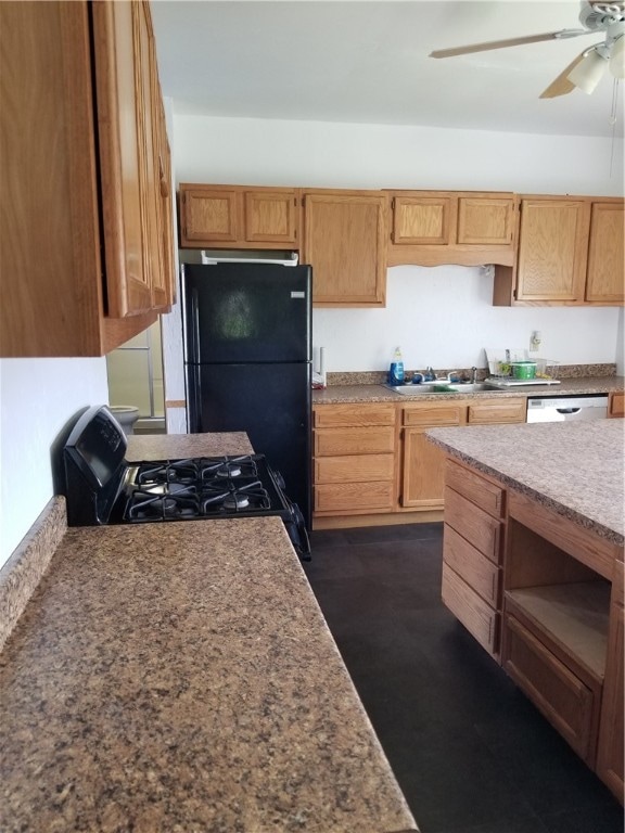 kitchen featuring ceiling fan, black refrigerator, range, sink, and dishwasher