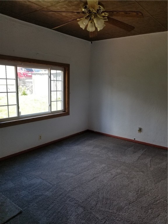 spare room featuring carpet floors and ceiling fan