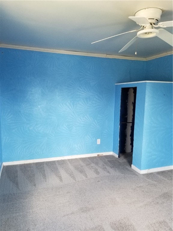 unfurnished room with ornamental molding, carpet floors, and ceiling fan