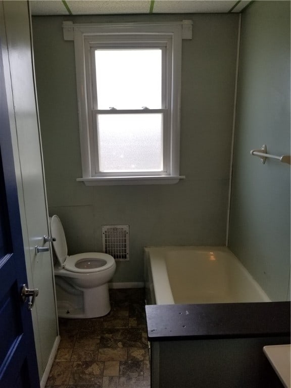 bathroom featuring vanity, tile patterned flooring, and toilet