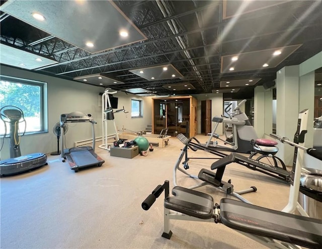 exercise room featuring a baseboard radiator and baseboards