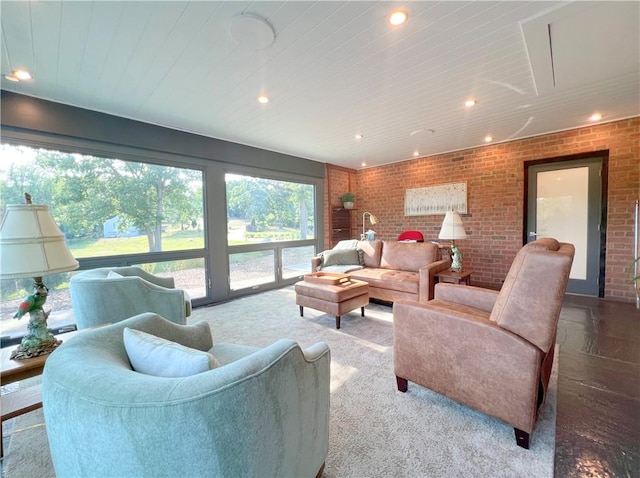 living area featuring brick wall and recessed lighting