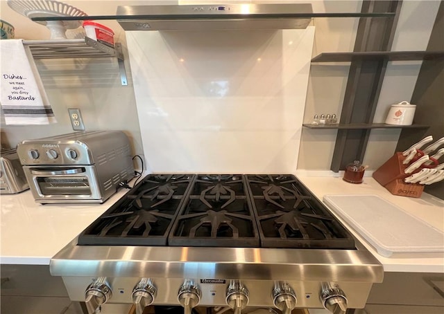 kitchen featuring stainless steel range and light countertops