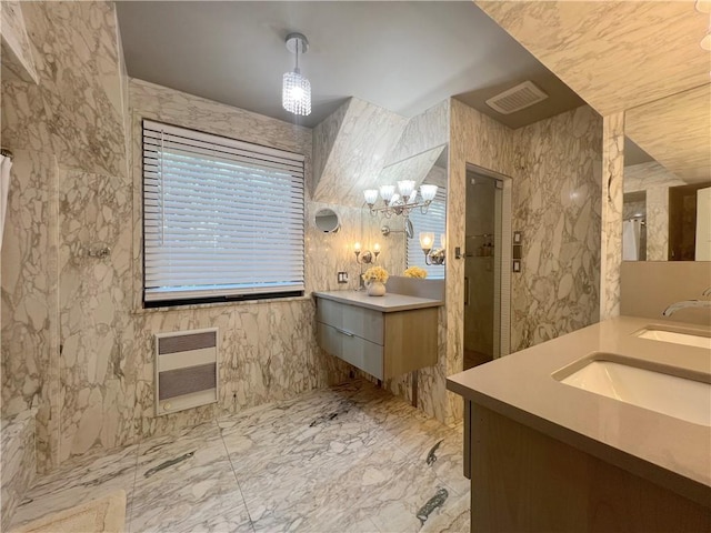 bathroom with visible vents, heating unit, a sink, a walk in shower, and two vanities