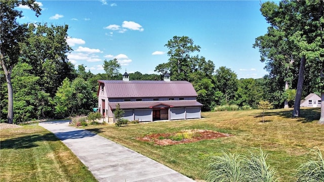 view of front facade featuring metal roof and a front lawn