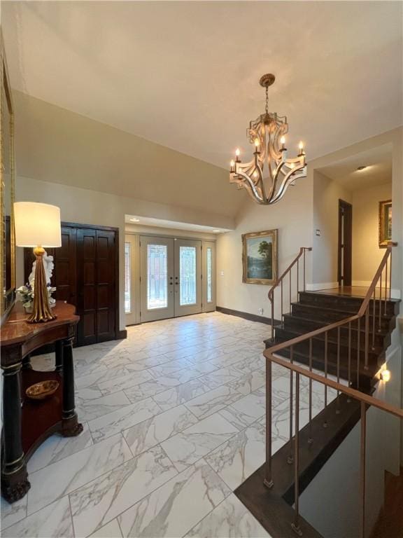 entrance foyer featuring baseboards, stairway, marble finish floor, french doors, and a notable chandelier