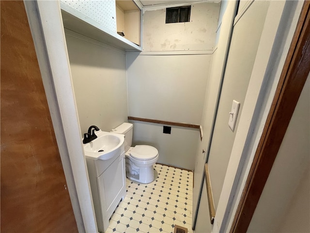 bathroom with tile patterned floors, vanity, and toilet