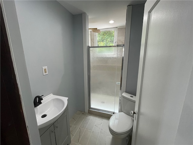 bathroom featuring tile patterned floors, vanity, an enclosed shower, and toilet