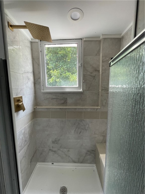 bathroom with a tile shower