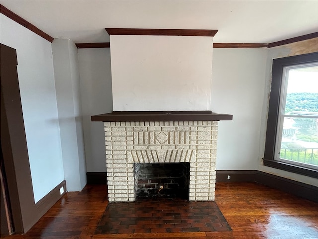 unfurnished living room featuring a fireplace, ornamental molding, and dark wood-type flooring