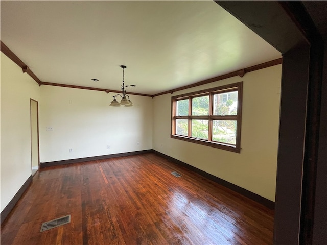 unfurnished room with dark wood-type flooring, a chandelier, and ornamental molding