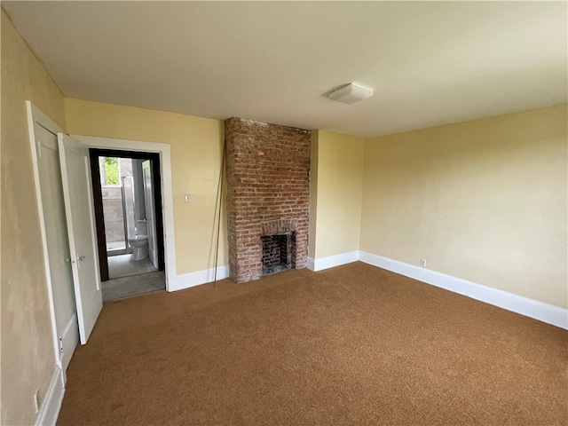 unfurnished living room with brick wall, carpet flooring, and a fireplace