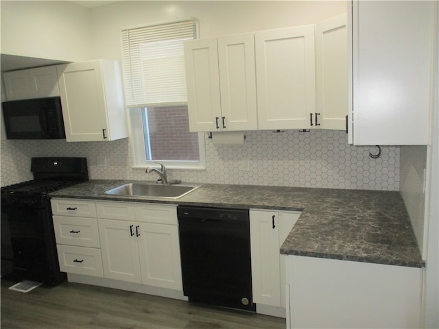 kitchen featuring decorative backsplash, dark wood-type flooring, sink, black appliances, and white cabinets