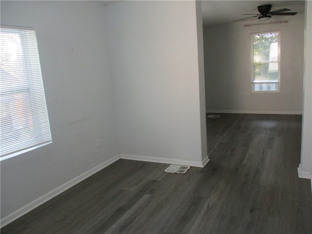 unfurnished room featuring dark hardwood / wood-style floors and ceiling fan