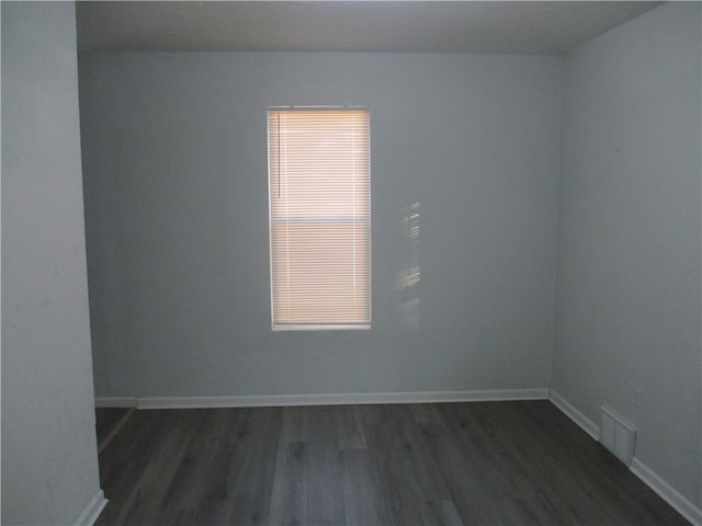 unfurnished room with dark hardwood / wood-style floors