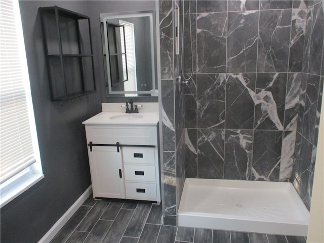 bathroom with vanity, a shower, and plenty of natural light