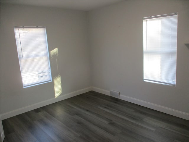 spare room featuring dark hardwood / wood-style floors