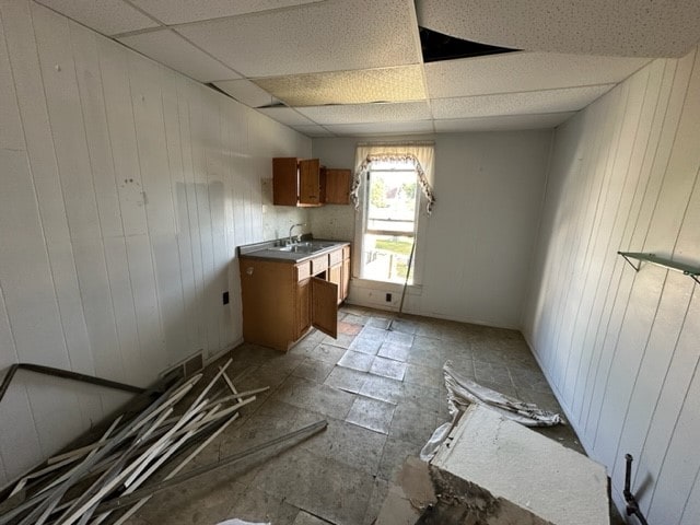 miscellaneous room featuring sink, light tile patterned flooring, and a paneled ceiling