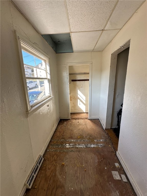 unfurnished bedroom featuring a drop ceiling