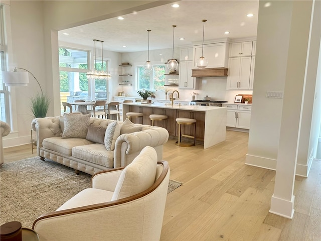 living room with sink and light hardwood / wood-style floors