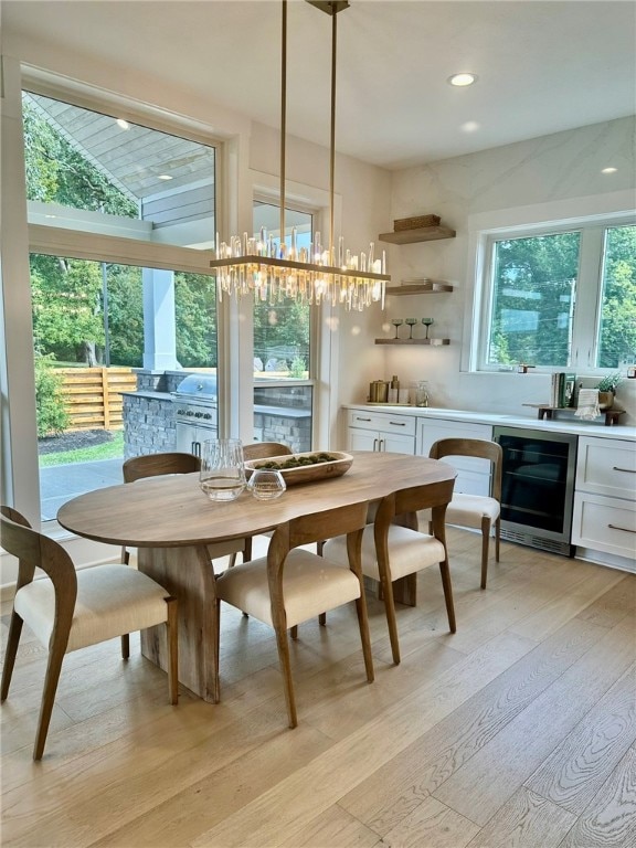 dining area featuring light hardwood / wood-style floors and beverage cooler