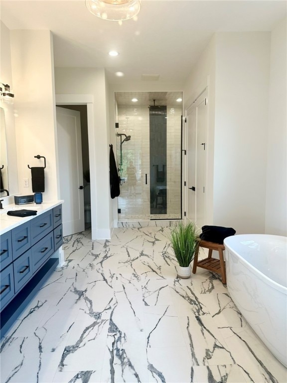 bathroom with vanity and separate shower and tub