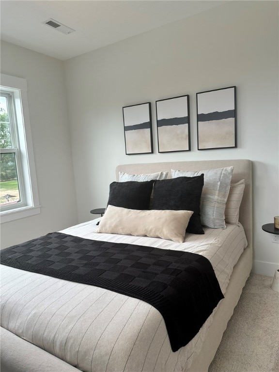 bedroom with light colored carpet