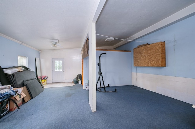 exercise room with crown molding, light carpet, and ceiling fan