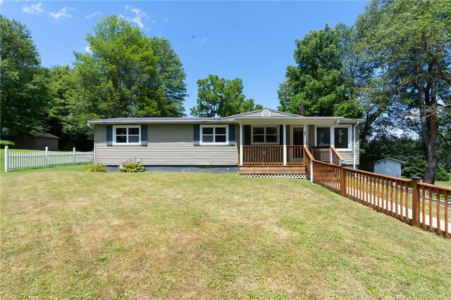 view of front of home with a front lawn and an outbuilding