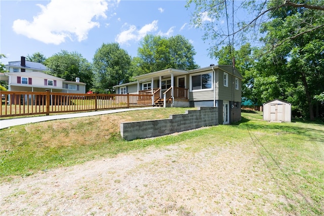 view of front of house with a storage shed and a front yard