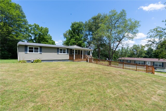 view of front of property with a deck and a front yard