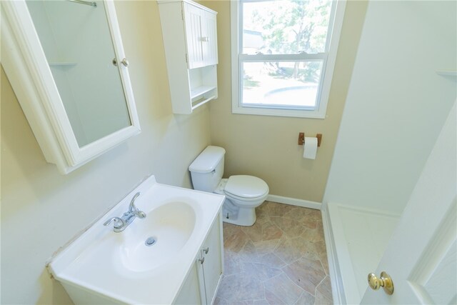 bathroom with tile patterned flooring, toilet, and vanity