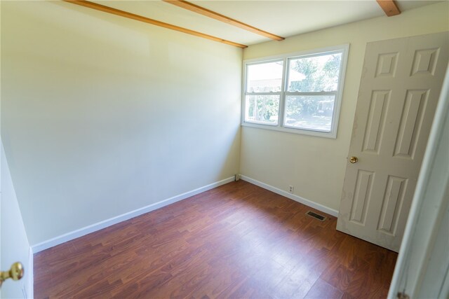 empty room featuring dark hardwood / wood-style floors