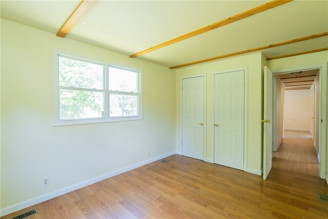 unfurnished bedroom with light wood-type flooring