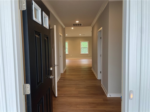 hallway with crown molding and wood-type flooring