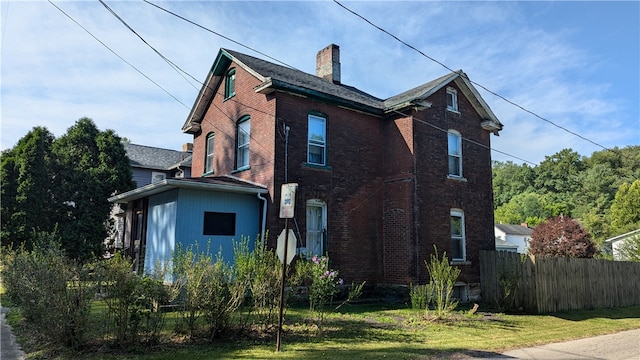 view of side of property with a lawn