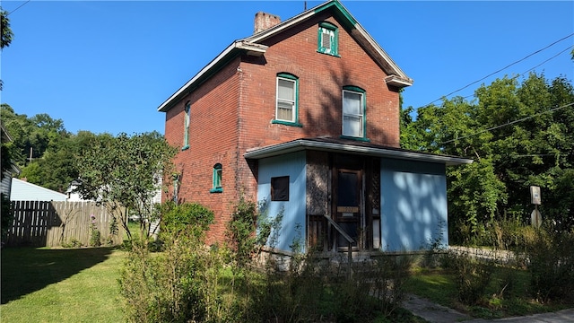 back of house with a yard