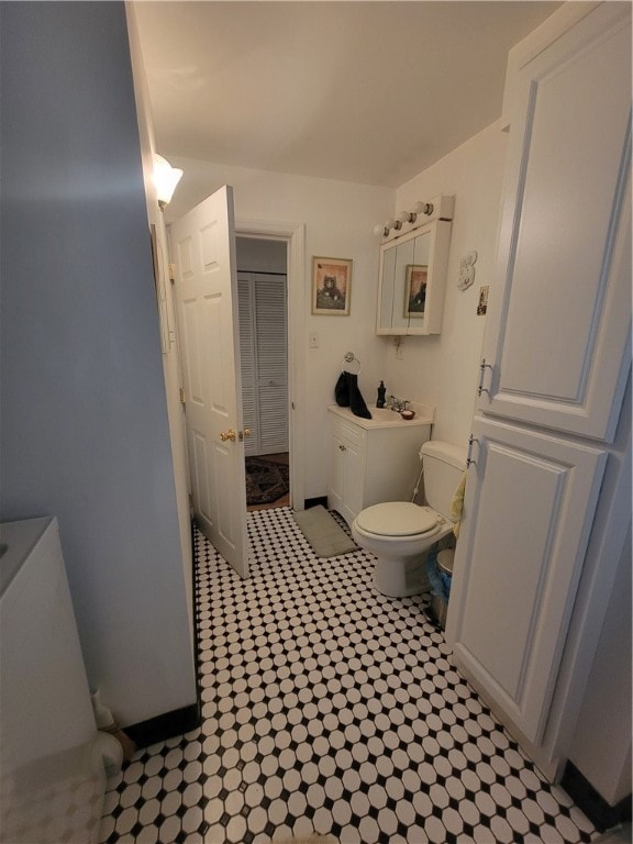 bathroom featuring vanity, toilet, and tile patterned flooring